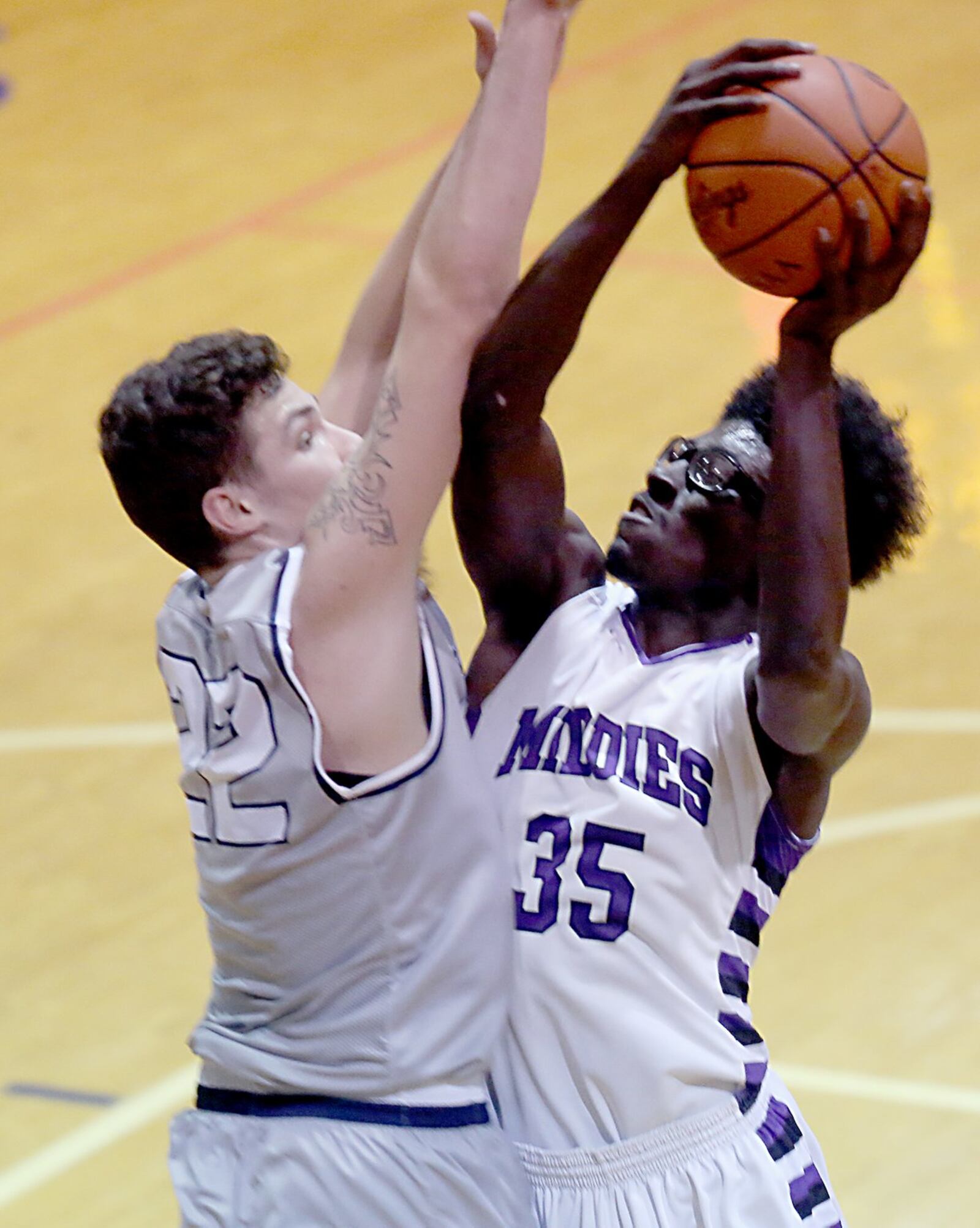 Middletown center Jomar Bailey draws a foul from Fairmont center Dylan Crutchfield during their game at Wade E. Miller Gym in Middletown on Wednesday night. CONTRIBUTED PHOTO BY E.L. HUBBARD