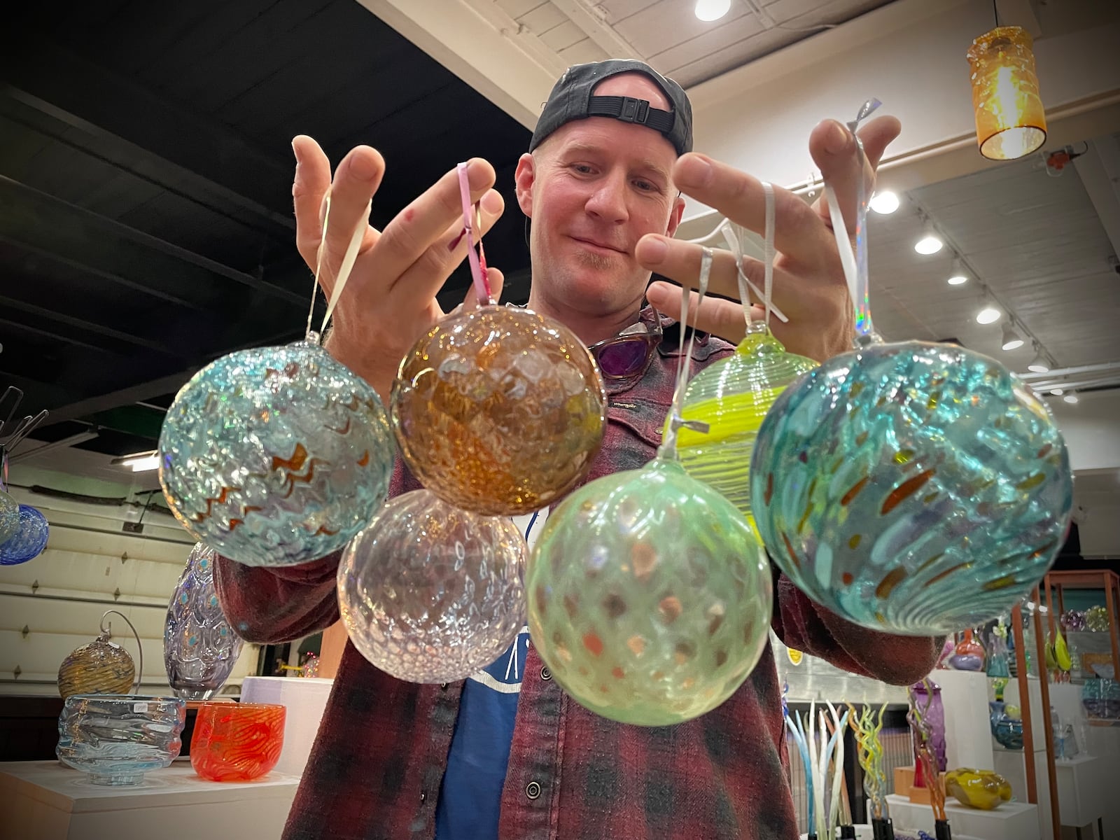 Nyminal Glass, a glass blowing studio and gallery in Dayton, is offering ornament making classes for the holiday season. Pictured is owner Dustin Wagner. NATALIE JONES/STAFF