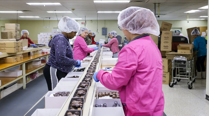 Esther Price employees work on a production line on Tuesday, March 3 at the company's factory headquarters on Wayne Avenue in Dayton. The company is celebrating its 100th anniversary. BRYANT BILLING / STAFF