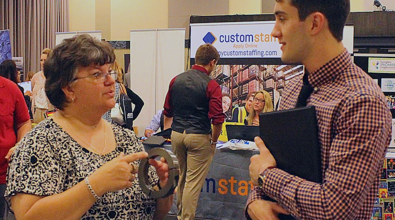 Jeannie Seery with Rose City Manufacturing explains to Dominic Finch what her employer makes has to offer to new hires. JEFF GUERINI/STAFF