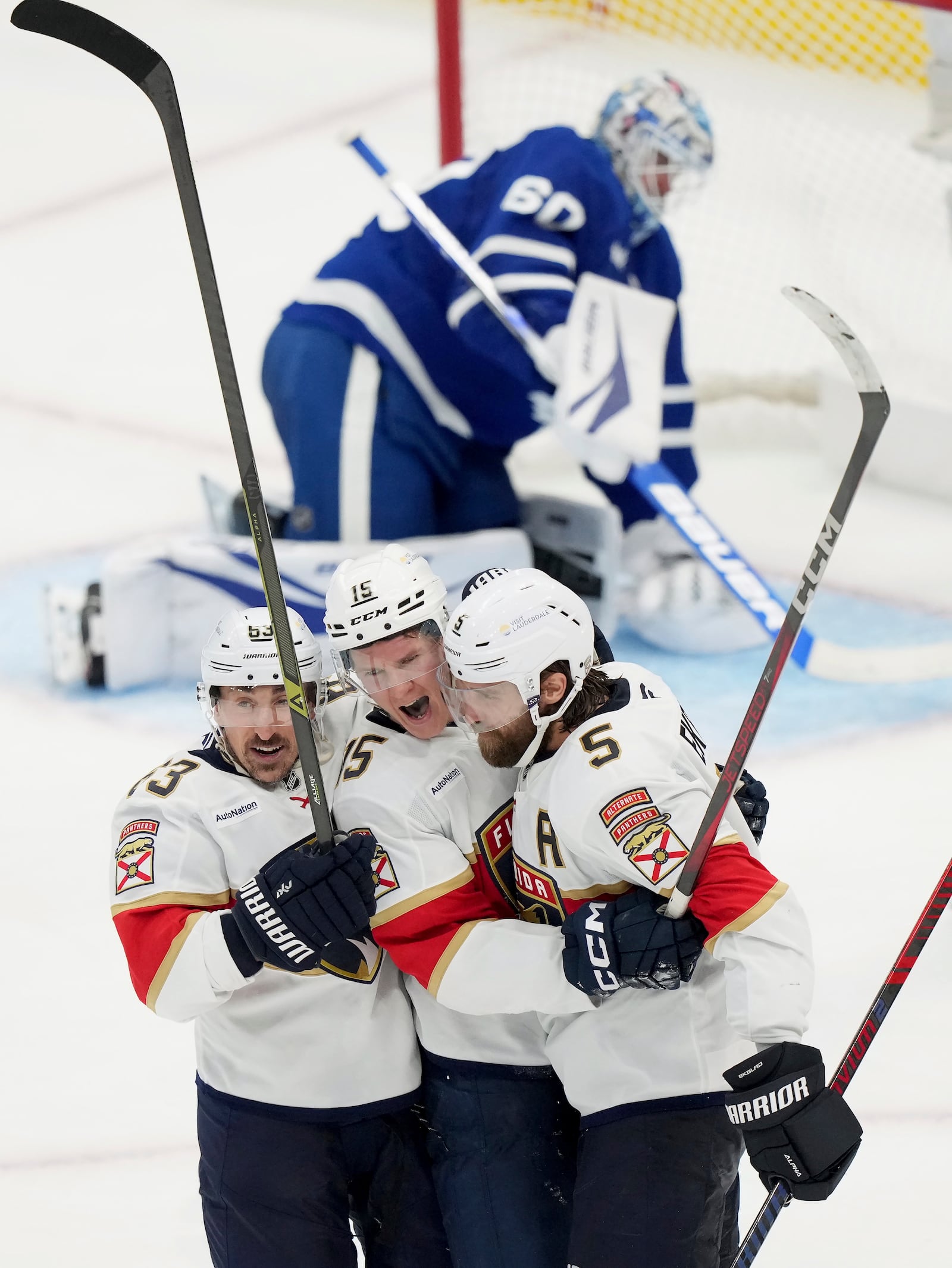 Florida Panthers' Anton Lundell (15) celebrates his goal with Brad Marchand (63) and Aaron Ekblad (5) during the third period of an NHL hockey playoff game against the Toronto Maple Leafs in Toronto on Wednesday, May 7, 2025. (Nathan Denette/The Canadian Press via AP)