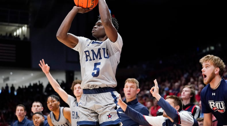 Robert Morris guard Enoch Cheeks (5) shoots a 3-pointer during the second half of an NCAA college basketball game, Saturday, Nov. 19, 2022, in Dayton, Ohio. (AP Photo/Joshua A. Bickel)