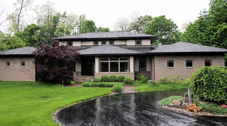 The 5-bedroom, brick-and-stucco home has about 6,535 sq. ft. of living space within three levels of open floor plans. The property is located on a cul-de-sac within the Hatcher Hills neighborhood of Oakwood. A paved circular driveway leads to the 3-car, side-entry garage. CONTRIBUTED PHOTO BY KATHY TYLER