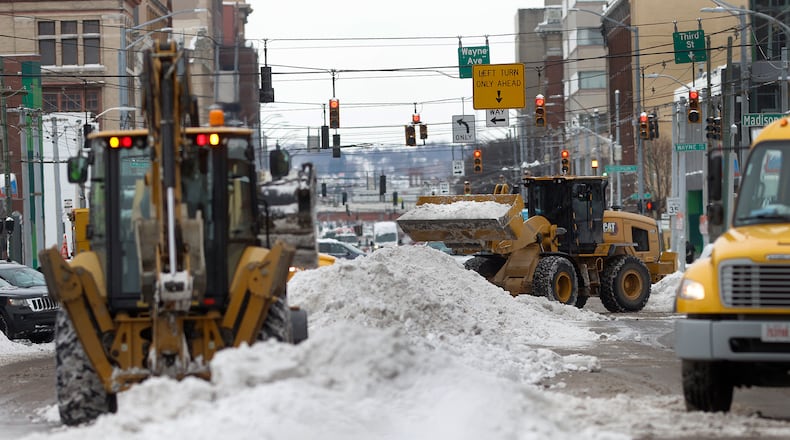 City of Dayton crews remove snow on East Third Street, Tuesday, Jan 7, 2024. MARSHALL GORBY\STAFF