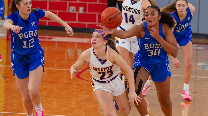 Springboro's Aniya Trent (30) and Bryn Martin trap Butler's Dillan Bardonaro and force a turnover during the first half of Saturday's Division I tournament game Saturday at Troy High School. Jeff Gilbert/CONTRIBUTED