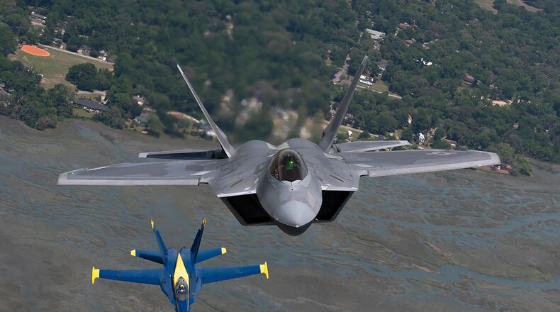 U.S. Air Force Maj. Paul ‘Loco’ Lopez, F-22 Demo Team commander/pilot, flies with the U.S. Navy Blue Angels in slot formation over the skies of Beaufort, South Carolina, April 25, 2019. (U.S. Air Force photo by 2nd Lt. Samuel Eckholm)