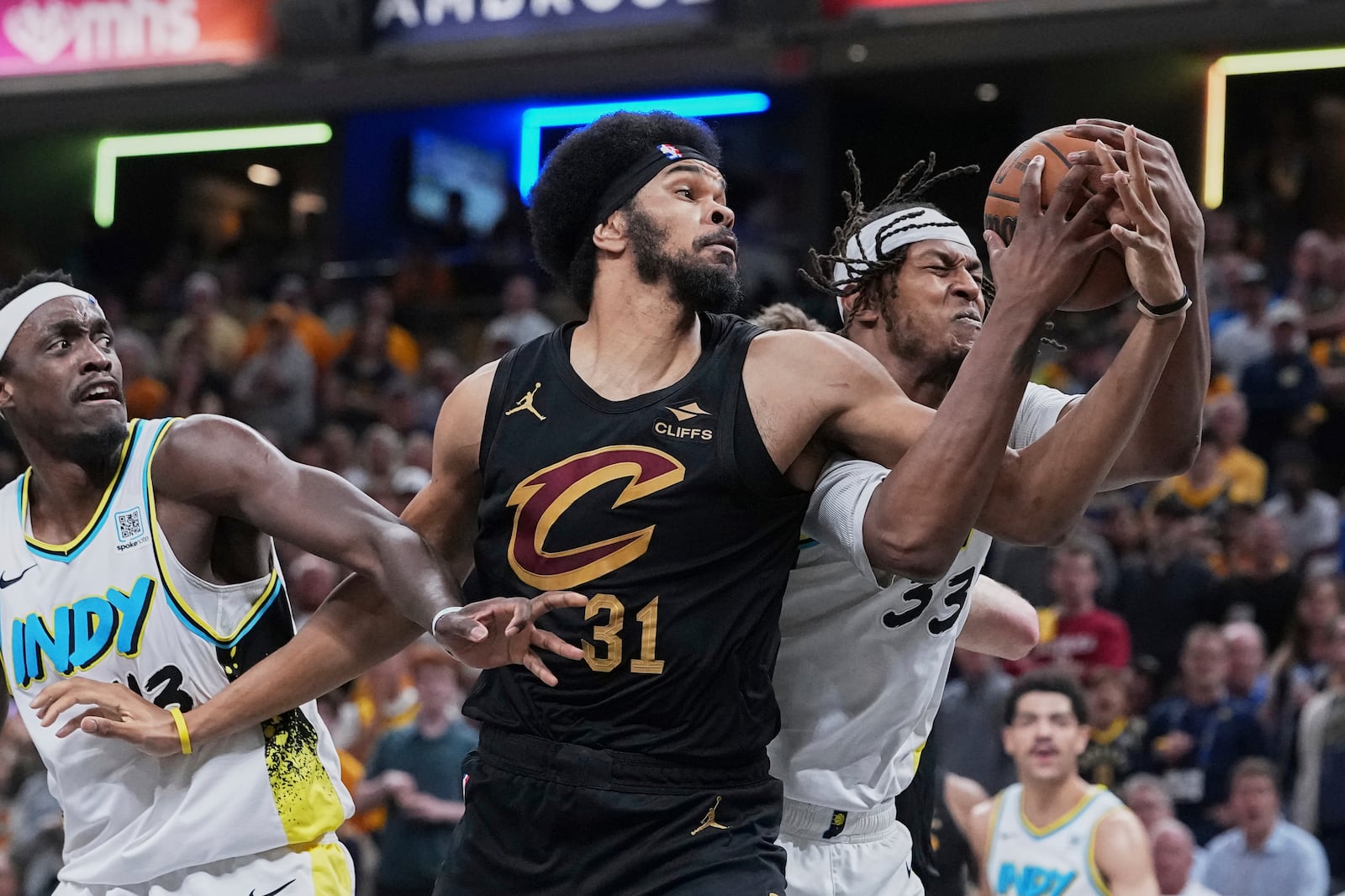 Cleveland Cavaliers center Jarrett Allen battles for the ball between Indiana Pacers center Myles Turner (33) and forward Pascal Siakam in the first half of Game 4 in the Eastern Conference semifinals of the NBA basketball playoffs in Indianapolis, Sunday, May 11, 2025. (AP Photo/Michael Conroy)