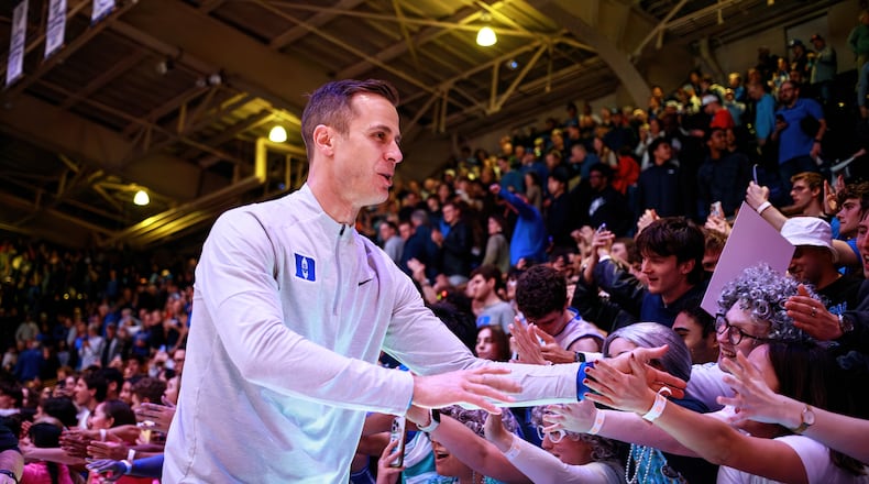 Duke head coach Jon Scheyer greets fans after his team defeated Syracuse in an NCAA college basketball game in Durham, N.C., Monday, Feb. 16, 2026. (AP Photo/Ben McKeown)