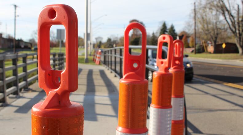 Orange plastic cones were placed on either ends of the Stroop Road bridge in Kettering. The bridge is expected to be replaced next year. CORNELIUS FROLIK / STAFF