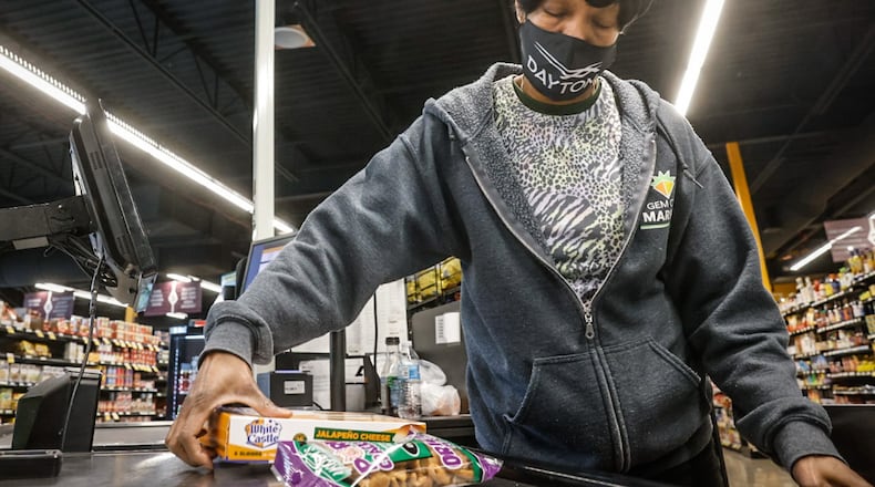 Gem City Market cashier Gerri Burell rings up groceries at the market Wednesday. The market's customers include those in the Supplemental Nutrition Assistance Program (SNAP). Emergency allotments for SNAP will end after February. JIM NOELKER/STAFF