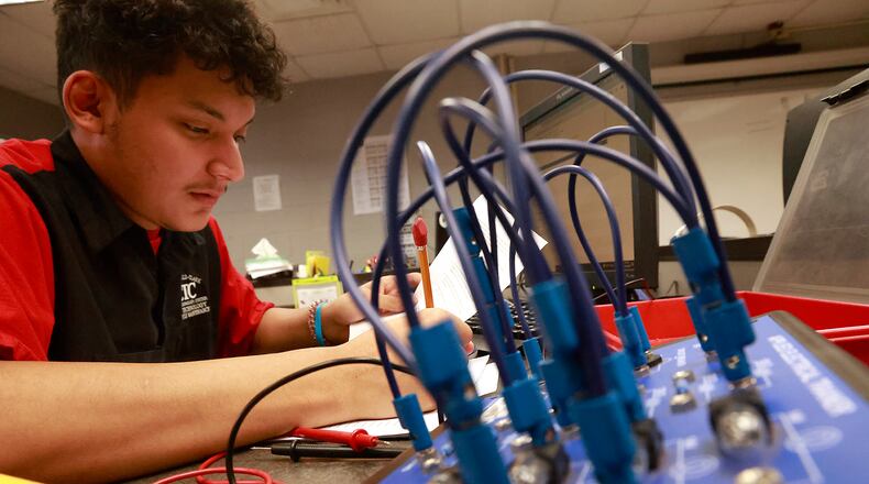 Steven Lopez Ramirez, a senior at Springfield High School, works in his Automotive Technology & Motorcycle Maintenance program at the Springfield-Clark CTC on Friday, Oct. 18, 2024. BILL LACKEY/STAFF