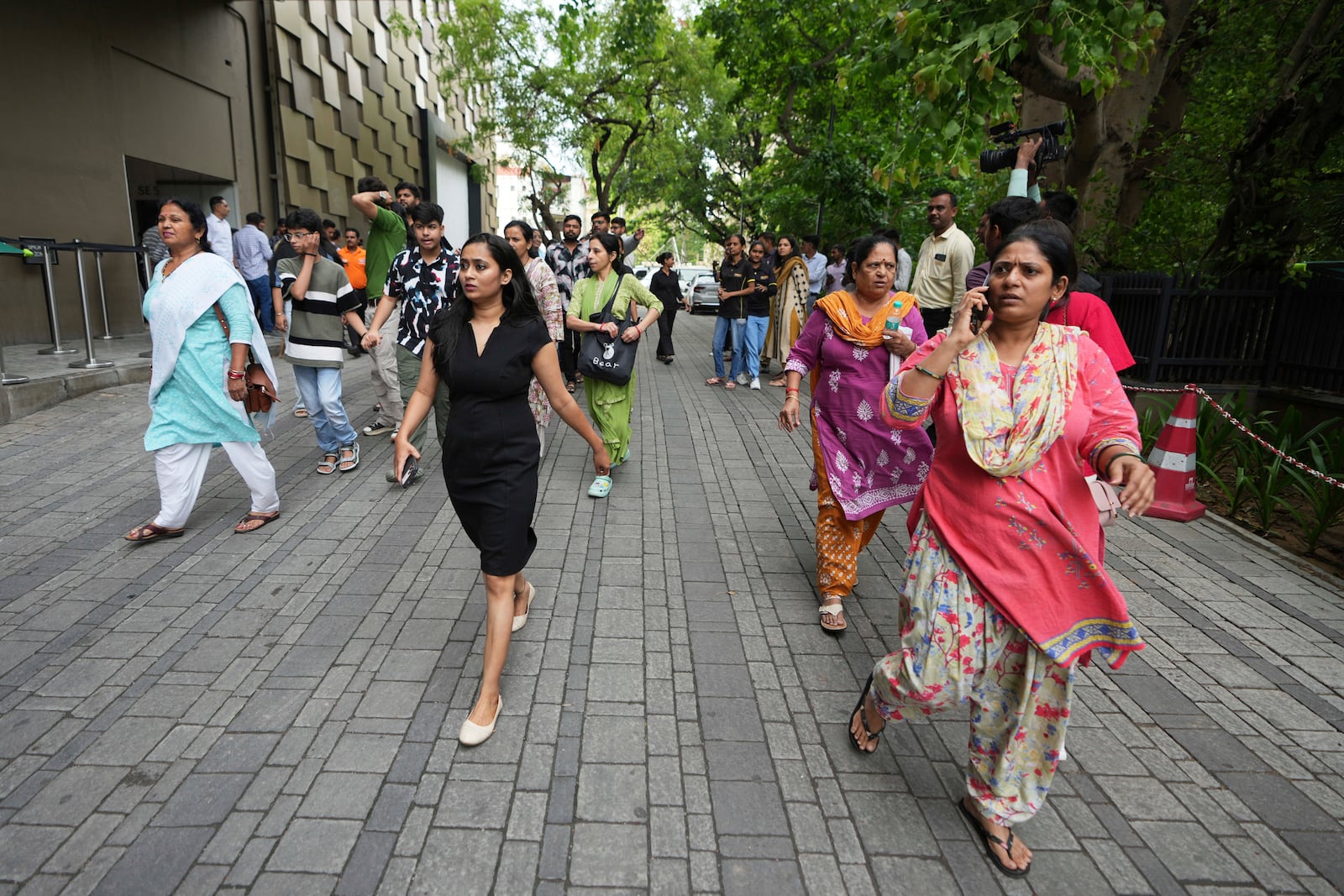 People rush to a safe place during a security mock drill at a mall in Ahmedabad, India, Wednesday, May 7, 2025, amid rising fears of wider conflict following India's strikes in Pakistan. (AP Photo/Ajit Solanki)