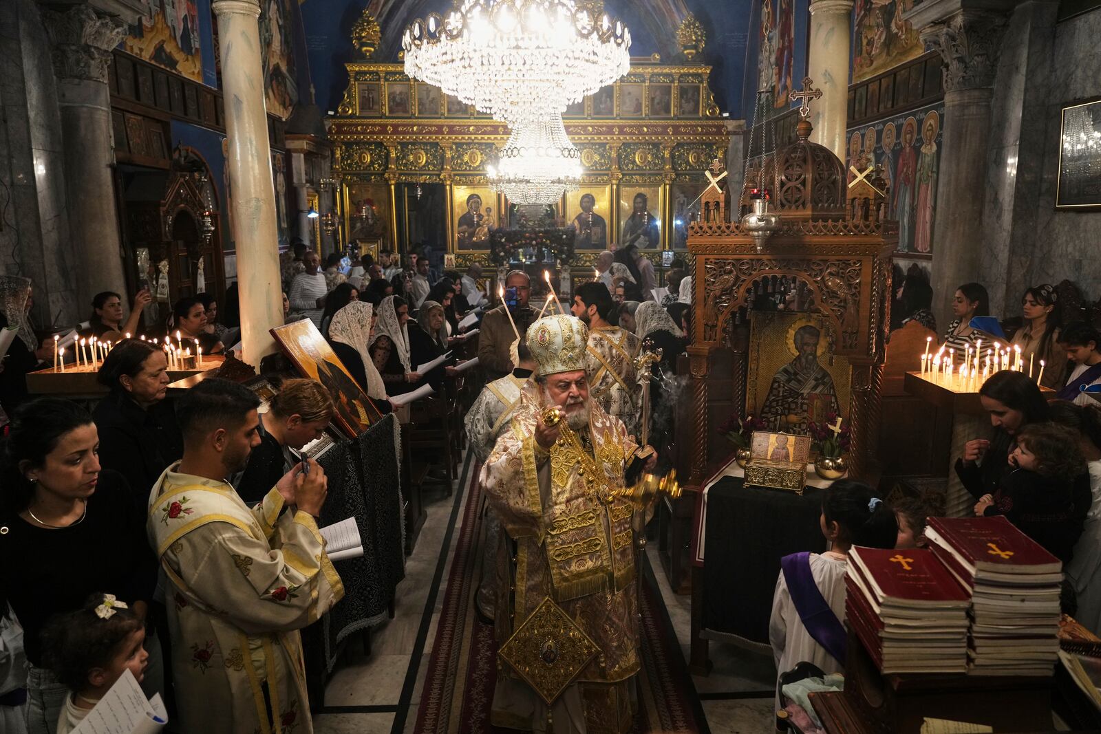 Palestinian Christians attend Good Friday mass at the Greek Orthodox Church of Saint Porphyrius in Gaza City, Friday, April 18, 2025. (AP Photo/Jehad Alshrafi)