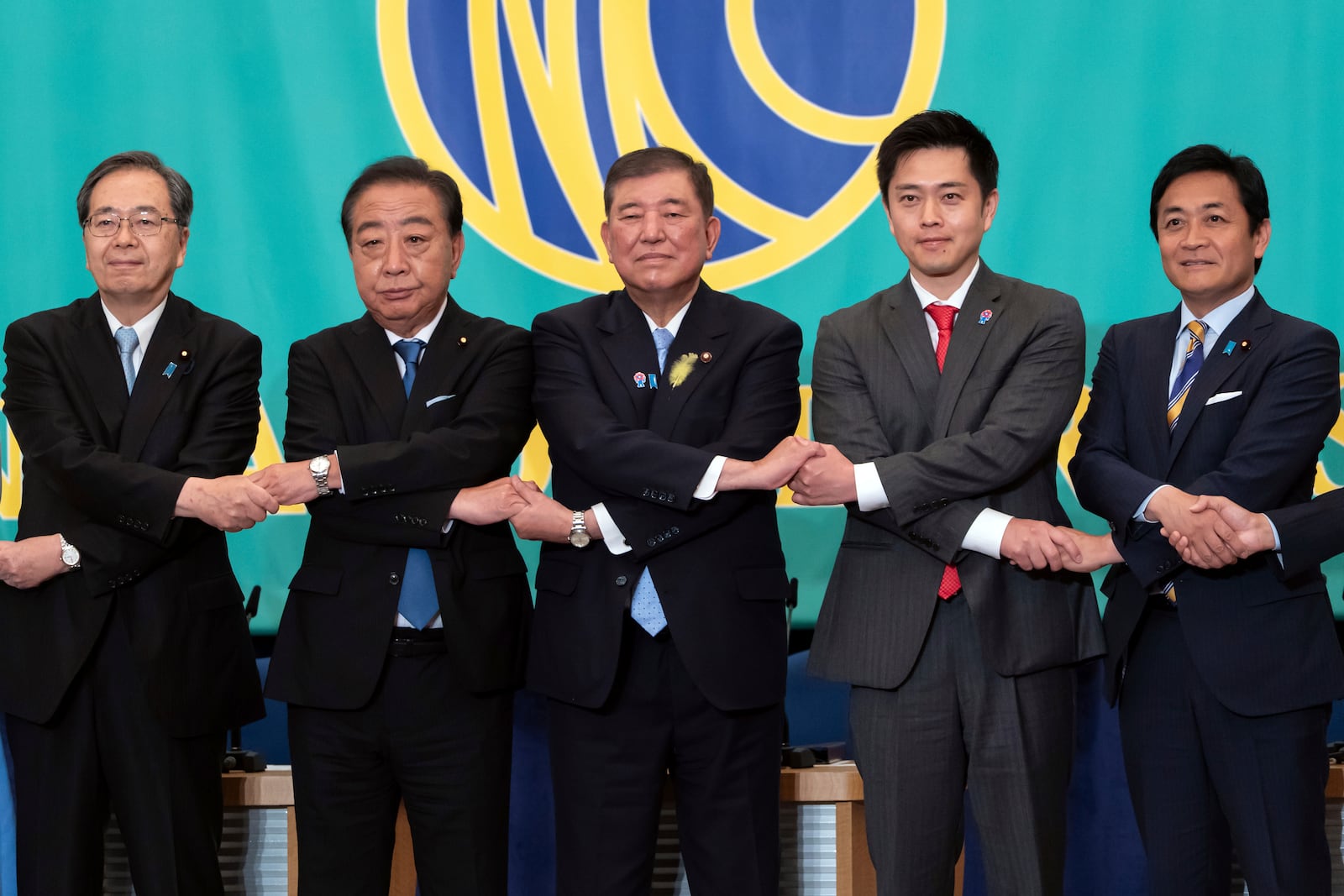 Leaders of eight political parties, from left to right, Komeito Chief Representative Tetsuo Saito, Constitutional Democratic Party of Japan leader Yoshihiko Noda, Japan's Prime Minister and Liberal Democratic Party leader Shigeru Ishiba, Japan Innovation Party Co-Representative Hirofumi Yoshimura and Democratic Party For the People Representative Yuichiro Tamaki pose before a debate at the Japan National Press Club in Tokyo, Japan, on July 2, 2025. (Tomohiro Ohsumi/Pool Photo via AP)