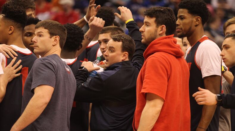 Players huddle around Dayton coach Archie Miller after practice on Thursday, March 16, 2017, at Bankers Life Fieldhouse in Indianapolis. David Jablonski/Staff