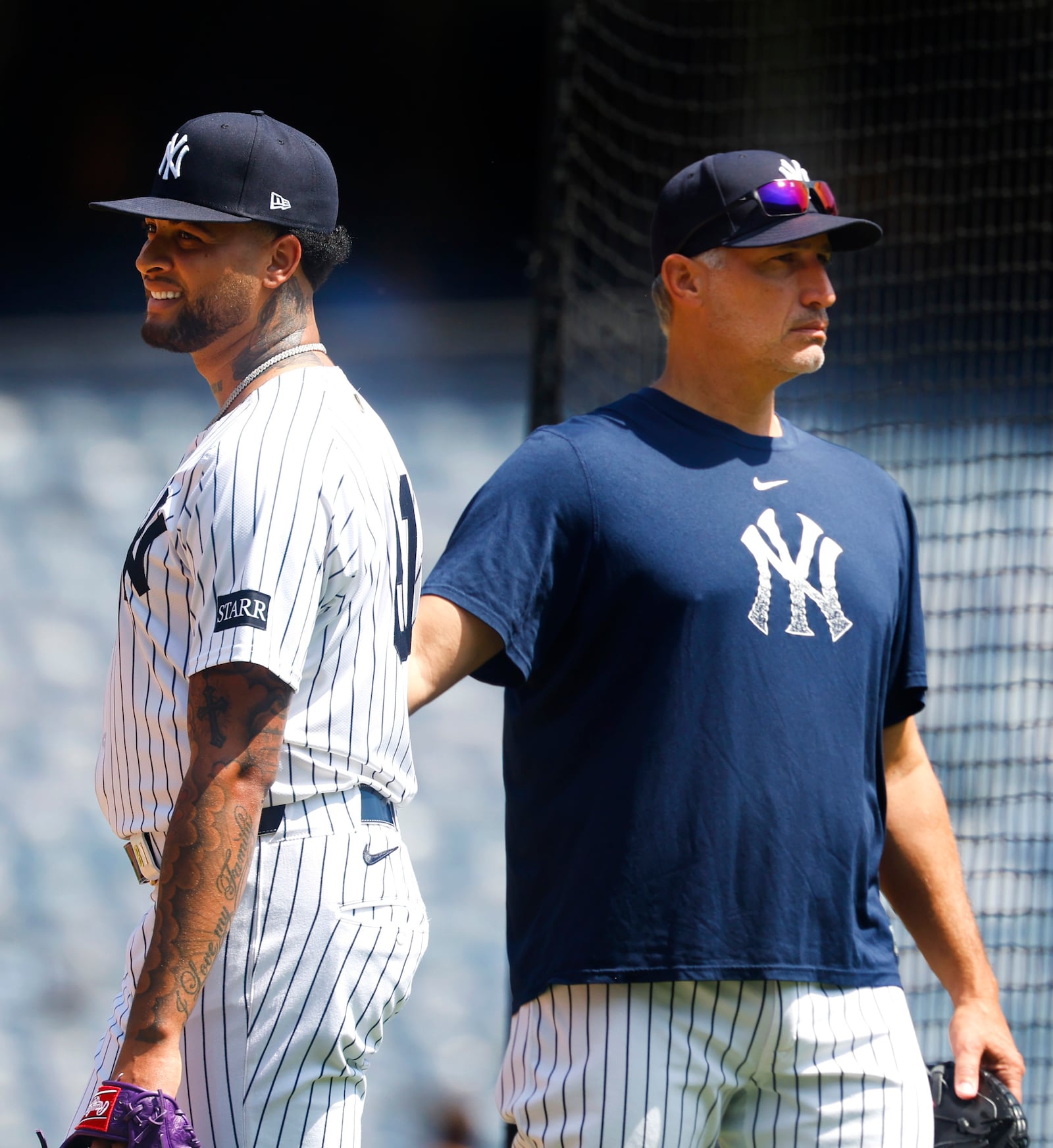 New York Yankees' Luis Gil, left, and Andy Pettitte, right, look on during live batting practice before a baseball game between the New York Yankees and the Baltimore Orioles, Saturday, June 21, 2025, in New York. (AP Photo/Noah K. Murray)
