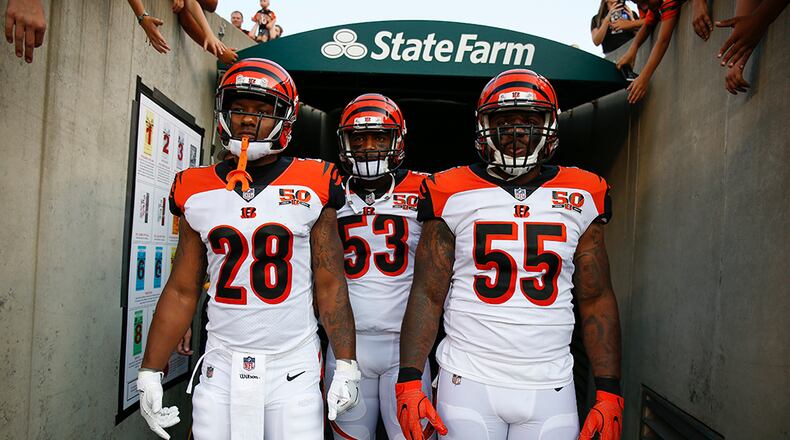 Cincinnati Bengals running back Joe Mixon (28), outside linebacker Marquis Flowers (53), and outside linebacker Vontaze Burfict (55) prepare to take the field before an NFL football game against the Tampa Bay Buccaneers, Friday, Aug. 11, 2017, in Cincinnati. (AP Photo/Gary Landers)