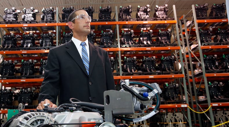 Lance Ibrahim, plant manager for Crown Equipment in Troy, was photographed in 2015 with the company’s 2.4L LPG engine for it’s C-5 series forklifts. Crown appears to be planning another regional expansion. TY GREENLEES / STAFF