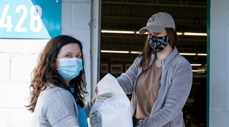 Sinclair's licensed social worker Julia Stidham picks up meals from Miami Valley Meals for the Sinclair Student Food Pantry. Courtesy of Sinclair Community College.