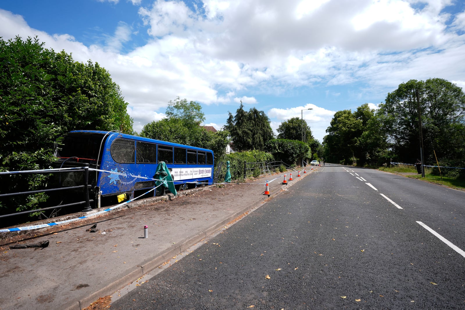 A double-decker bus carrying high school students after it came off the road and plunged into a river, in Eastleigh, England, Thursday June 26, 2025. (Andrew Matthews/PA via AP)