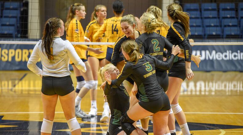 Wright State players celebrate winning a point in a victory over West Virginia on Aug. 25, 2018. CONTRIBUTED