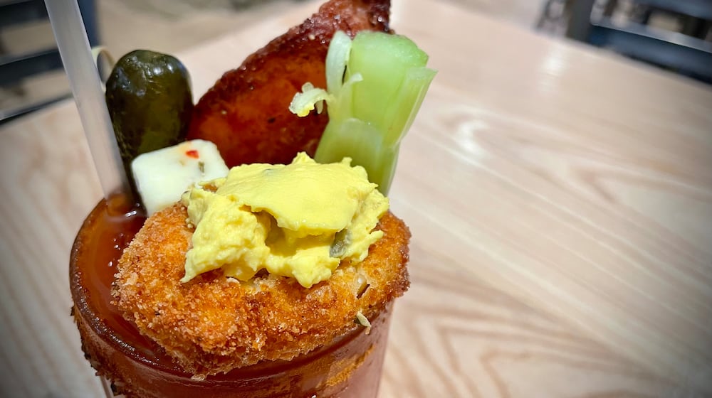 Loose Ends Brewing Company is located at 890 S. Main St. in Centerville. Pictured is the brewery's Bloody Mary featuring The Bloody Mary included a bacon salt rim, sweet heat candied bacon, a deep-fried deviled egg, sweet gherkin, pepper jack cheese, celery and lime. NATALIE JONES/STAFF