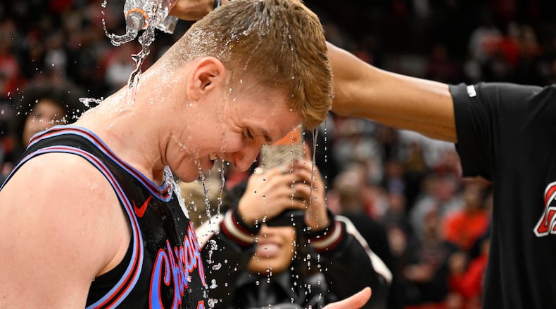 Chicago Bulls guard Kevin Huerter gets doused with water after an NBA basketball game against the Boston Celtics, Saturday, Jan. 24, 2026, in Chicago. Huerter scored the game winning three-point basket. (AP Photo/Matt Marton)