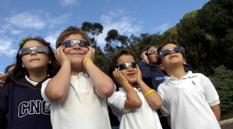 Students view a partial solar eclipse at a school in Bogota, Colombia in 2005. (AP Photo/Zoe Selsky)