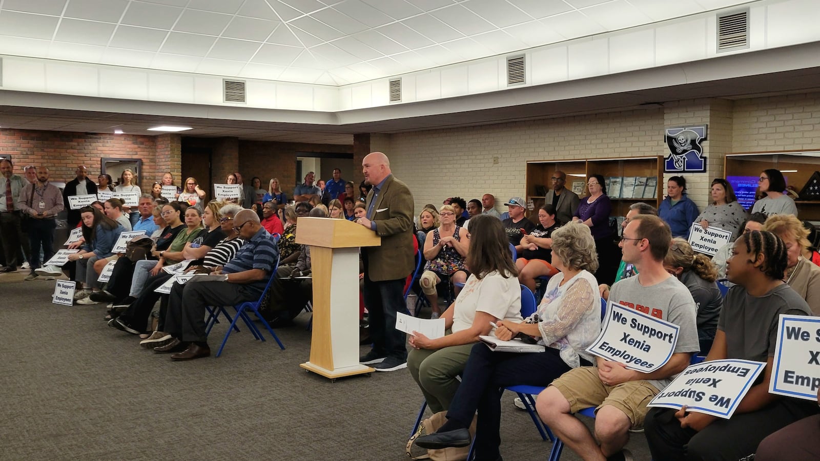 Aaron McCray speaks at the podium during a standing-room-only meeting of the Xenia Board of Education, October 13, 2025. LONDON BISHOP/STAFF