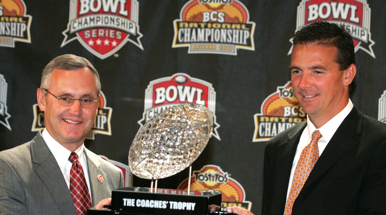 7 Jan 07 Photo by Ron Alvey. Jim Tressel (left), the Ohio State football coach, pose for a picture with Florida Gator coach Urban Meyer. The two are in front of one of the college fooball championship trophies. The two teams play Monday night in the BCS Championship Game.
