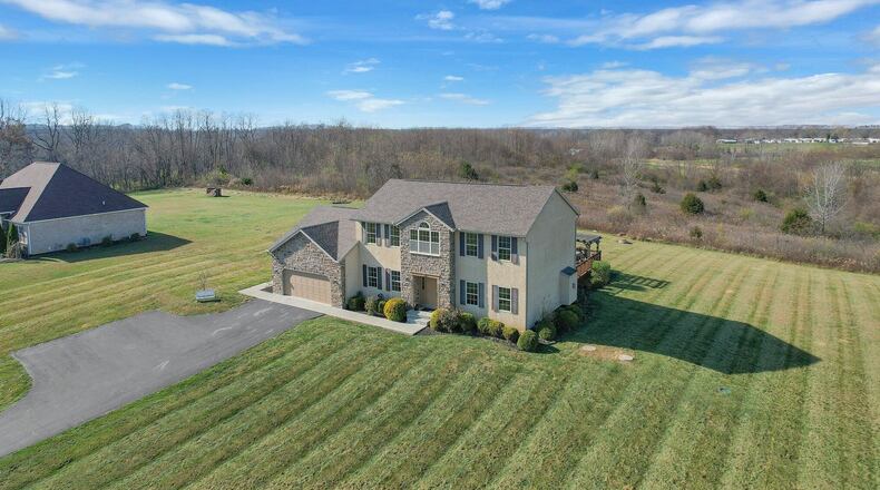 The two-story, stone-and-stucco home sits on an acre lot with views of the public golf course. Contributed photo