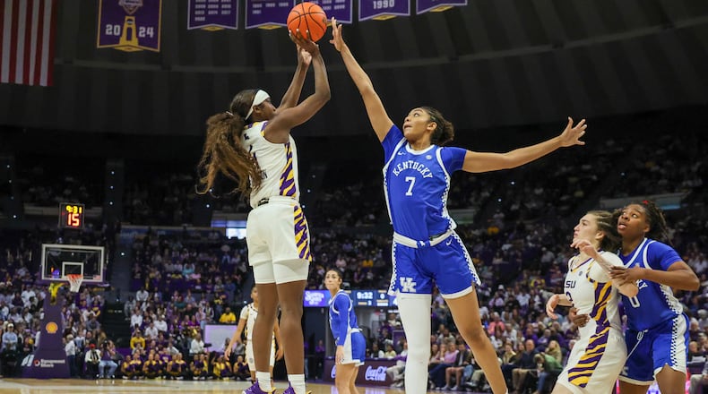 LSU guard Flau'Jae Johnson, left, shoots a jumper over Kentucky forward Teonni Key (7) in the second half of an NCAA college basketball game in Baton Rouge, La., Thursday, Jan. 1, 2026. (AP Photo/Peter Forest)