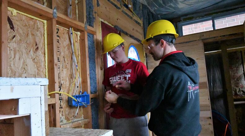 Tippecanoe High School student Noah McElhose works with teacher Jim Kitchen as work on the inside of the first tiny house, a project by the school homebuilding classes, continues to take shape. Work has begun on a second tiny house. CONTRIBUTED