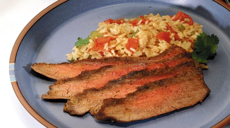 A quick rub with chili powder turns a plain flank steak into a spicy dinner. (Bob Fila/Chicago Tribune/TNS)