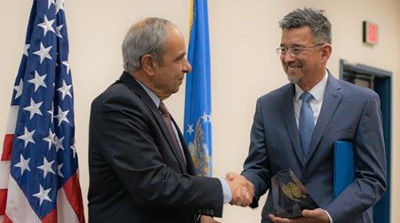 Dr. Richard Joseph, chief scientist of the Air Force, left, presents Air Force Research Laboratory scientist Dr. Robert Johnson the 2018 Harold Brown Award in a ceremony at AFRL’s Starfire Optical Range on Nov. 21. (U.S. Air Force photo/Macee Hunt)