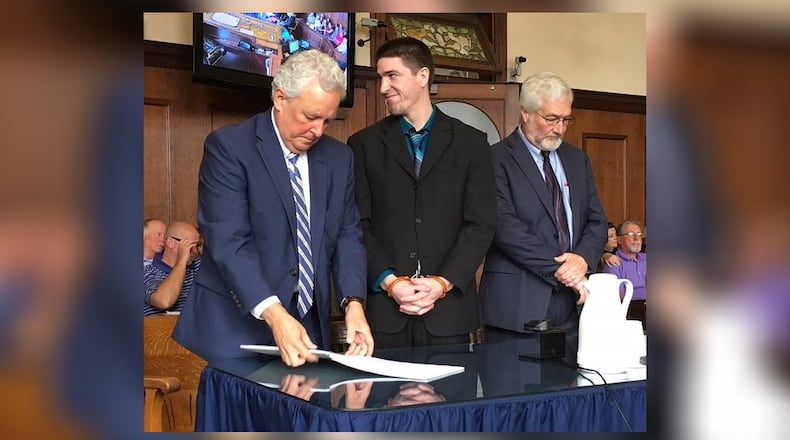 Dustin Merrick, flanked by his attorneys Gregory Meyers (to his left) and Kirk McVay (to his right), smiled at his family prior to being sentenced to life in prison without the possibility of parole Wednesday, Sept. 12, 2018. RICHARD WILSON/STAFF