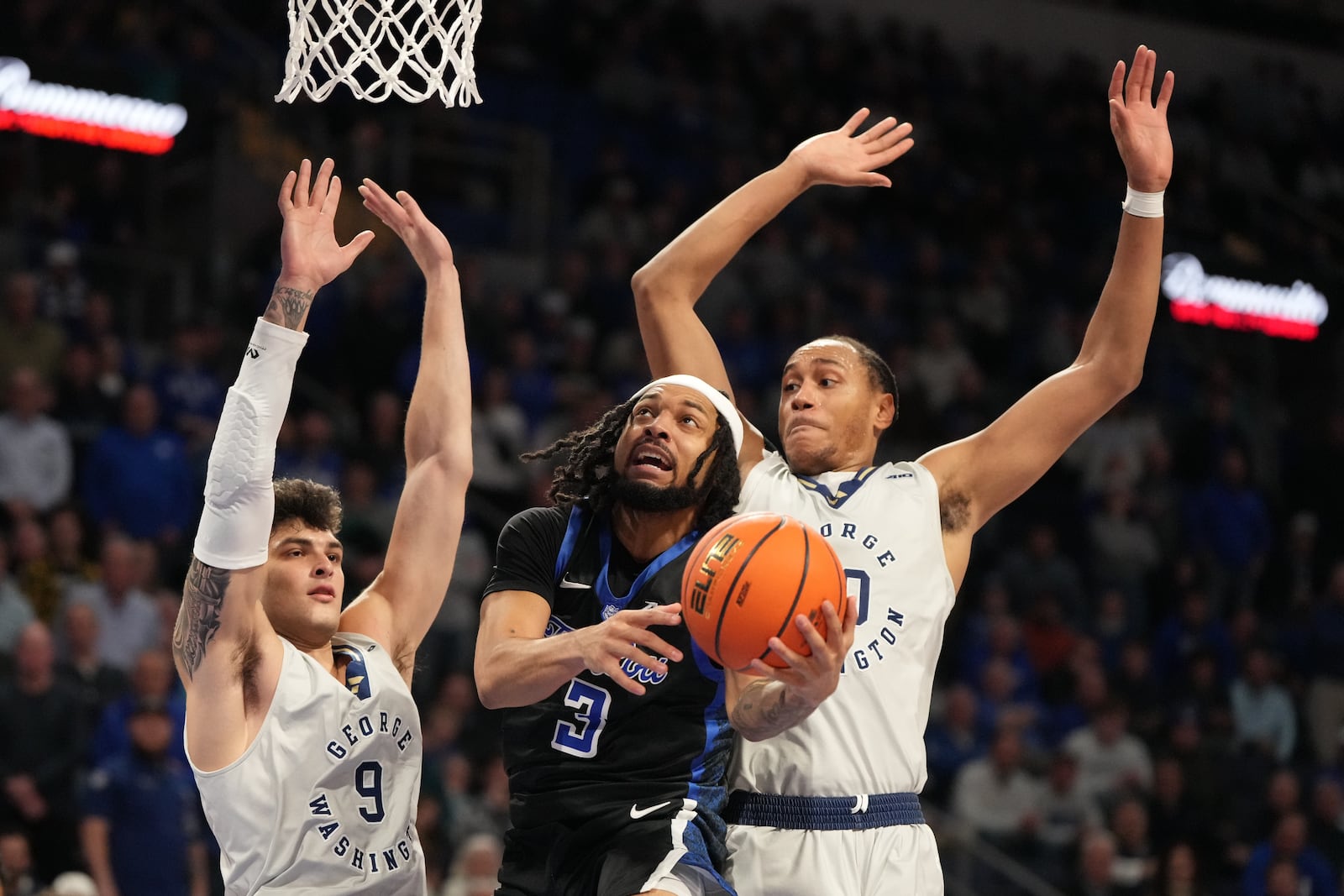 Saint Louis' Trey Green (3) heads to the basket as George Washington's Rafael Castro, right, and Garrett Johnson (9) defend during the second half of an NCAA college basketball game Tuesday, Jan. 27, 2026, in St. Louis. (AP Photo/Jeff Roberson)