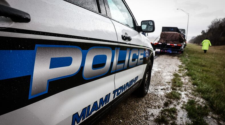 Miami Twp. police officer Brandon Young assists a motorist after a crash on Interstate 75 Tuesday April 4, 2023. Miami Twp. will ask voters to approve a permanent 5.75-mill property tax levy in May to help fund its police department. JIM NOELKER/STAFF