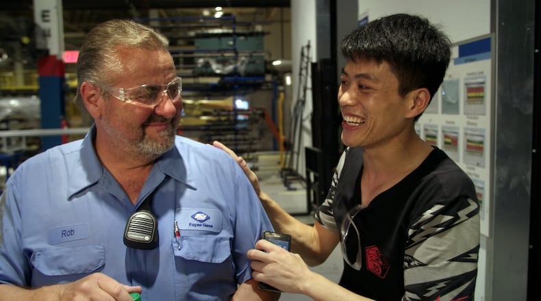 Rob Haerr and Wong He working together at the Fuyao Glass America plant in Moraine, in a photo from the film “American Factory.” CONTRIBUTED