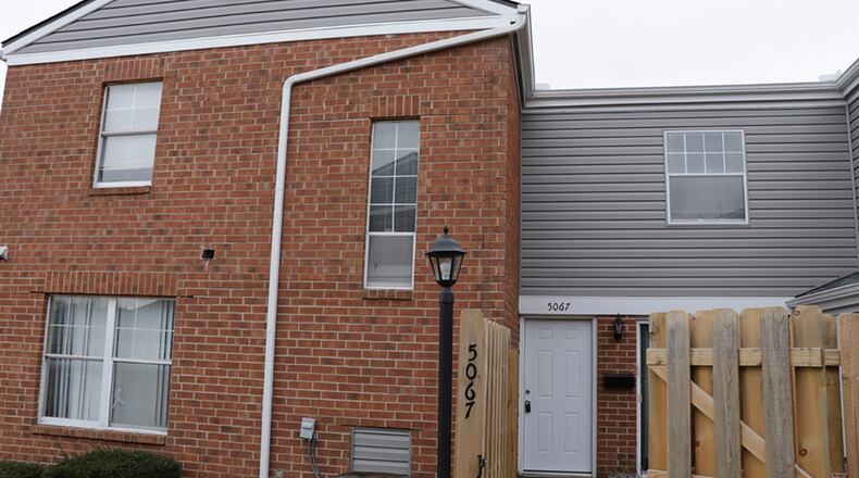 An updated wooden privacy fence surrounds a courtyard setting and formal entry of this 2-story condominium. The 2-bedroom condominium, with about 1,230 sq. ft. of living space, has first-floor social areas and has a 1-car attached garage. CONTRIBUTED PHOTO BY KATHY TYLER