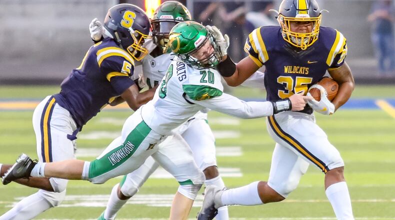 Springfield High School senior Jeff Tolliver greets Northmont’s Andrew Knick during their Week 4 game. The visiting Wildcats won 28-17. CONTRIBUTED PHOTO BY MICHAEL COOPER