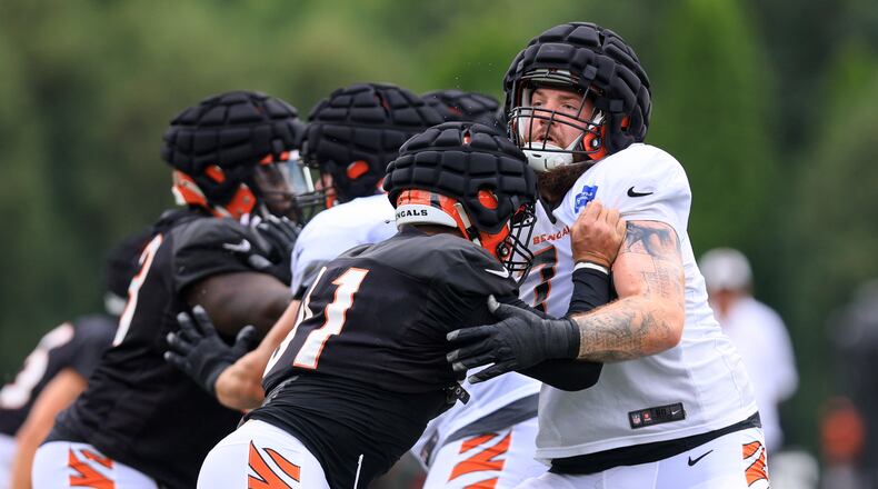 Cincinnati Bengals' Trey Hendrickson, left, works against Jonah Williams during NFL football training camp in Cincinnati, Monday, Aug. 15, 2022. (AP Photo/Aaron Doster)