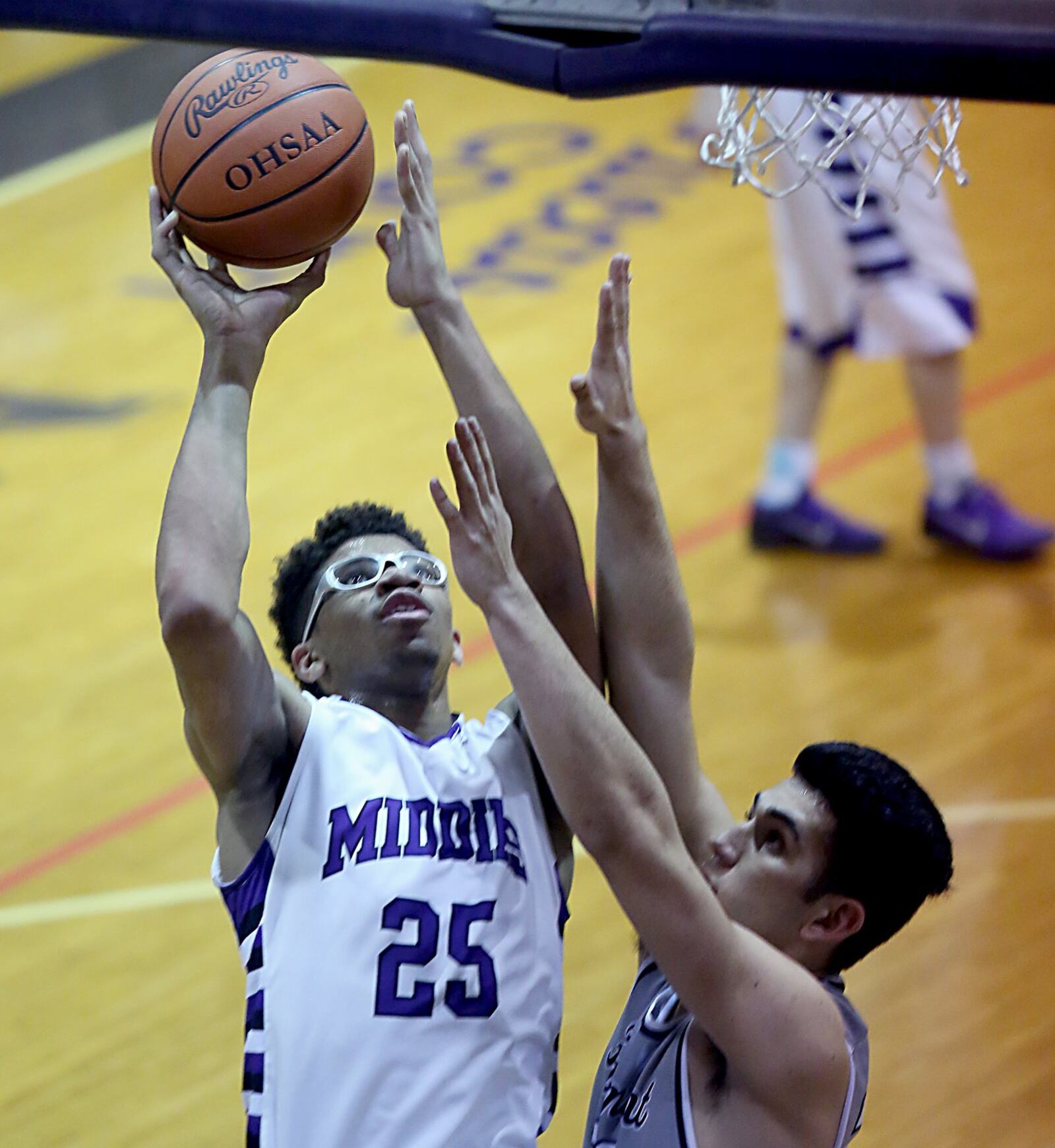 Middletown center Jawunn Bailey puts up a shot over Fairmont forward Brandon Hall on Wednesday night at Wade E. Miller Gym in Middletown. CONTRIBUTED PHOTO BY E.L. HUBBARD