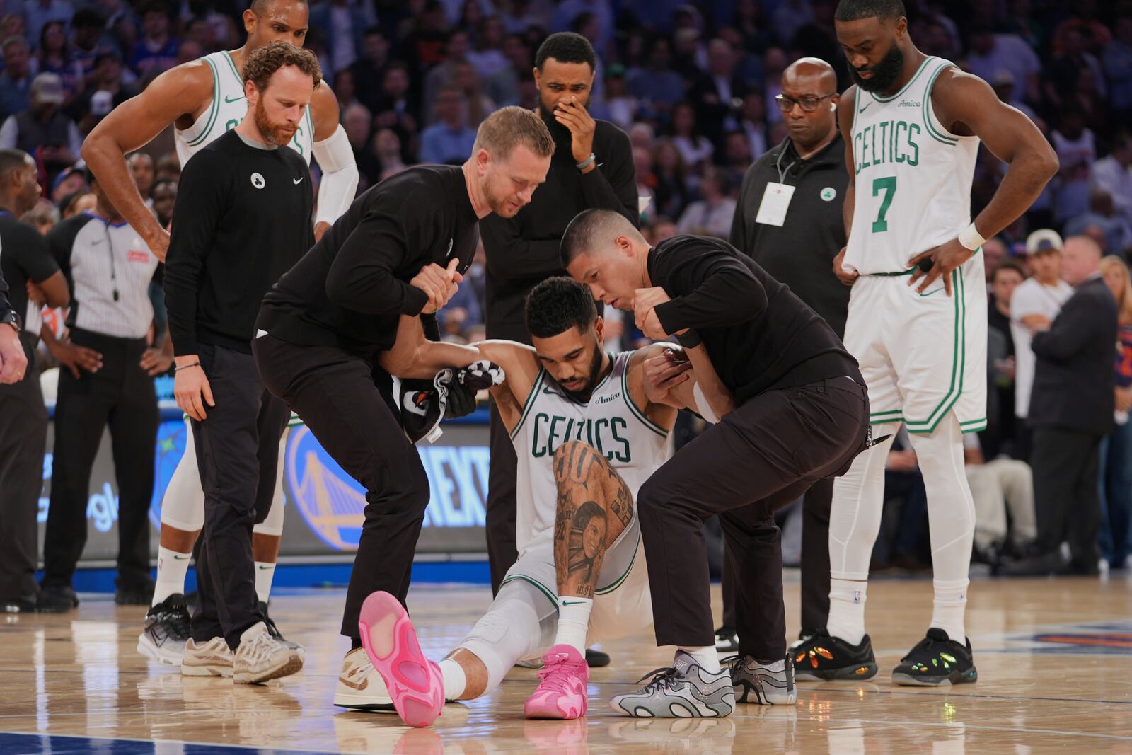 Trainers help Boston Celtics' Jayson Tatum (0) off the court after he was injured during the second half of Game 4 in the Eastern Conference semifinals of the NBA basketball playoffs against the New York Knicks Monday, May 12, 2025, in New York. (AP Photo/Frank Franklin II)
