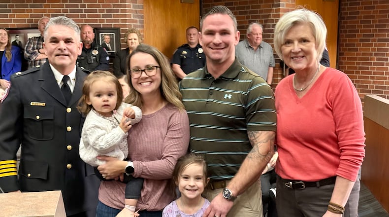The city of Miamisburg and the Miamisburg Police Department honored West Carrollton residents Katelynn and Matthew Pope (center) with a Certificate of Appreciation at the Miamisburg City Council meeting on Tuesday, April 1, for helping them find a murder suspect last month. Pictured with the Popes are their children, plus Miamisburg Police Chief Mike Brem (left) and Miamisburg Mayor Michelle Collins (right). CONTRIBUTED