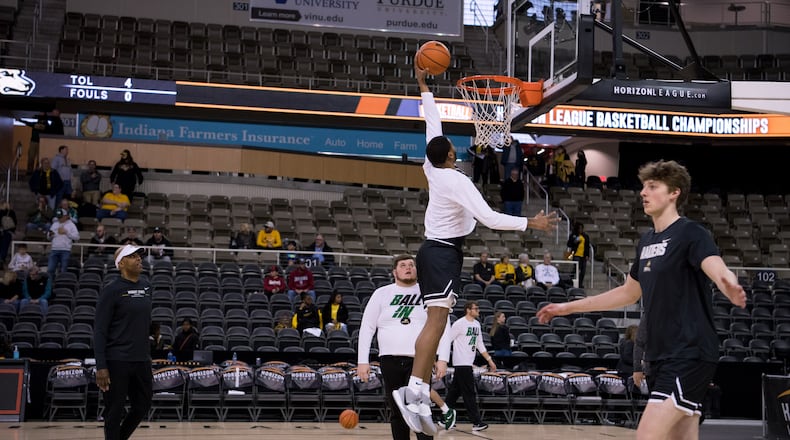 Wright State assistant coach Travis Trice (left) watches pre-game warmups before Tuesday night's Horizon League championship game at Indiana Farmers Coliseum. Joe Craven/Wright State Athletics