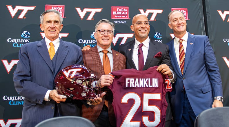 FILE - James Franklin, second from right, Virginia Tech's new head football coach, holds up a No. 25 jersey with, from left, Virginia Tech Board of Visitors memver John Rocovich, Virginia Tech President Timothy Sands and Athletic Director Whit Babcock, after Franklin was introduced during an NCAA college football news conference, Wednesday, Nov. 19, 2025, in Blacksburg, Va. (AP Photo/Robert Simmons, File)