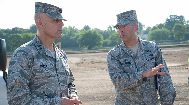 Col. Thomas Sherman, 88th Air Base Wing and Installation commander, talks to Maj. Gen. Bradley D. Spacy, Air Force Installation and Mission Support Center commander, about construction at the new Gate 26A site during the general’s visit to the installation July 12. Spacy received updates on a number of issues being worked on at sites around the base while also getting a chance to meet with Airmen. (U.S. Air Force photo/John Harrington)