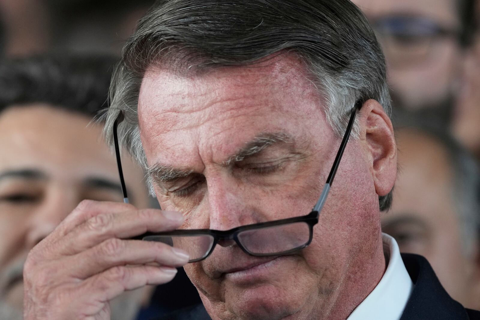 Brazil's former President Jair Bolsonaro speaks to the press at Congress in Brasilia, Brazil, Wednesday, March 26, 2025, after panel of Brazil Supreme Court justices accepted charges against him over an alleged attempt to stay in office after his 2022 election defeat. (AP Photo/Eraldo Peres)