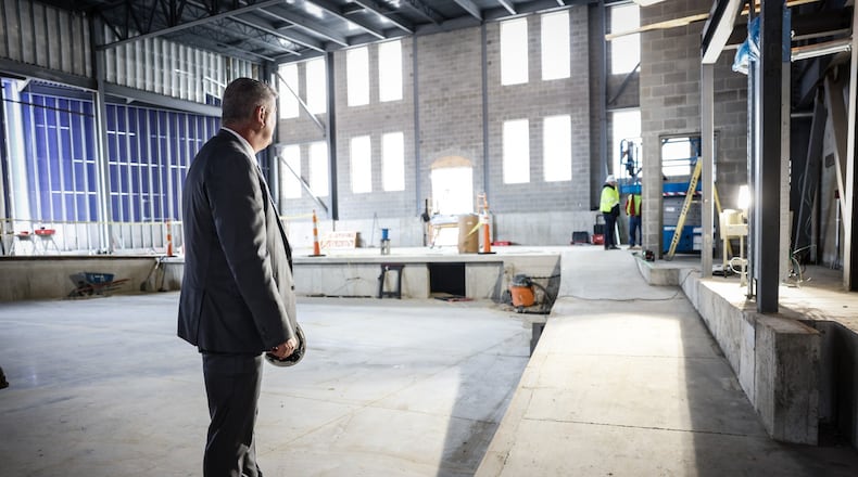 Wayne Local Schools Superintendent, Pat Dubbs stands in what will be the performing arts center on the school campus. Construction is expected to be completed in August. JIM NOELKER/STAFF